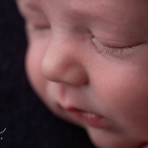 Macro shot of newborn baby boy's long eyelashes