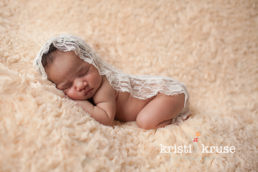 sleeping newborn with lace wrap
